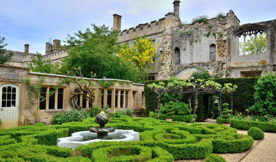 Formal garden with topiary hedges in front of ruins. Credit: David Hamilton